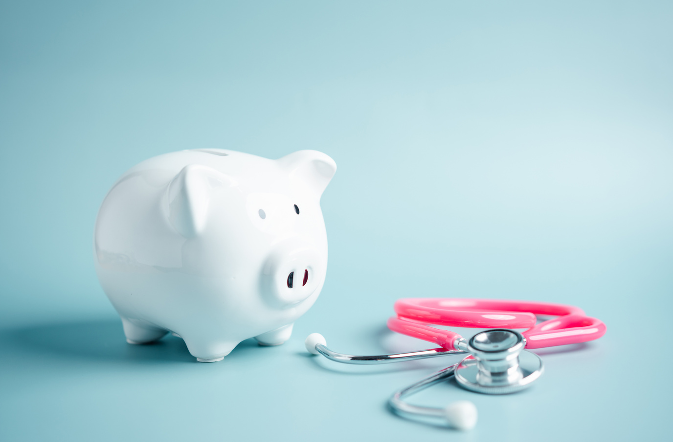 Piggy bank with stethoscope. money health check concept. Health